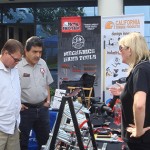 The representative from Bessey answers questions from a few customers.